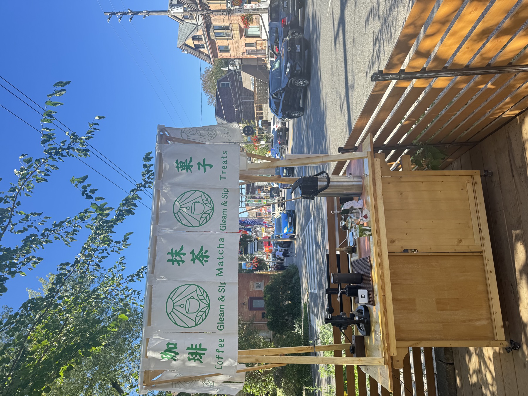 Handmade wooden market counter on a sunny Toronto street