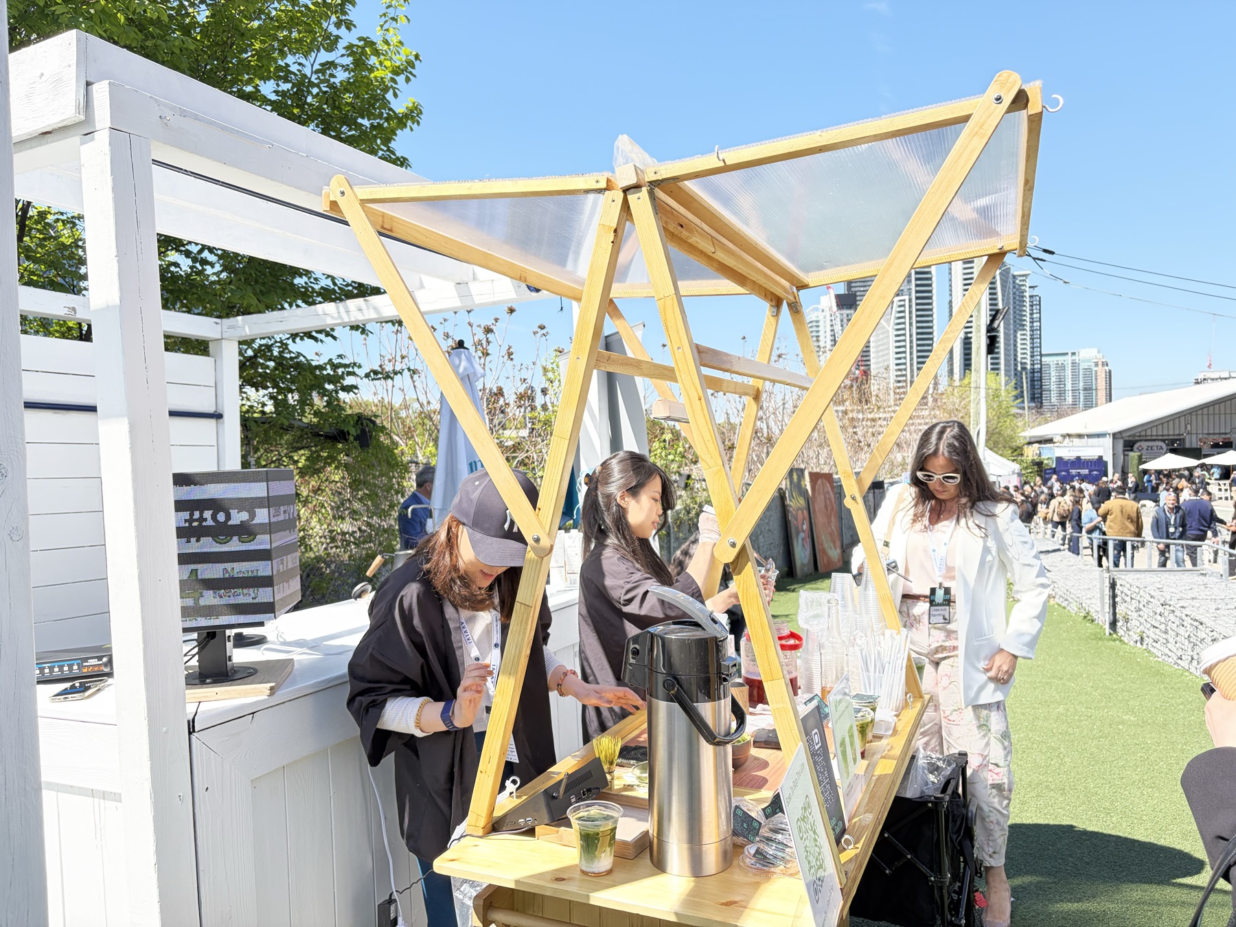 Market team serving visitors from a handmade wooden stall at an outdoor Toronto event